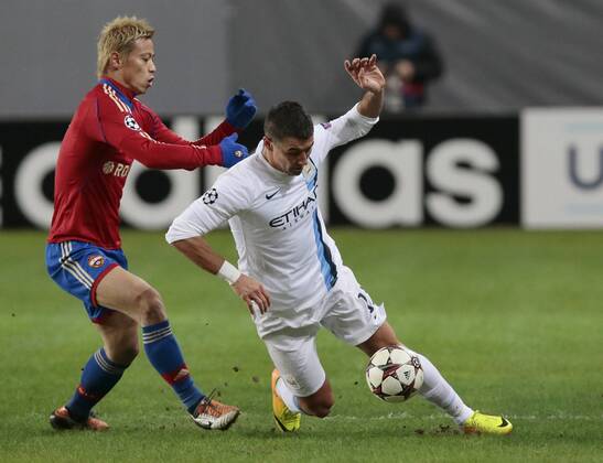 ITAR-TASS: MOSCOW REGION, RUSSIA. OCTOBER 23, 2013. CSKA s Keisuke Honda (red) and Man. City s Alexander Kolarov in action during a UEFA Champions League game CSKA Moscow vs. Manchester City.  premiumd RE12DA95
