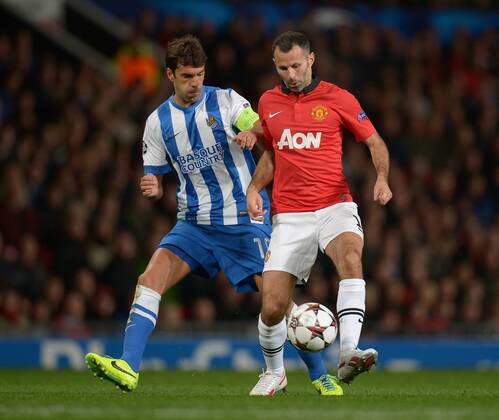 Ryan Giggs of Manchester United tussles with Xabi Prieto of Real Sociedad - UEFA Champions League Group A - Manchester Utd vs Real Sociedad - Old Trafford Stadium - Manchester - England - 23 10 13 - EDITORIAL USE ONLY. No use with unauthorised audio, video, data, fixture lists, club league logos or live services. Online in-match use limited to 120 images, no video emulation. No use in betting, games or single club league player publications.