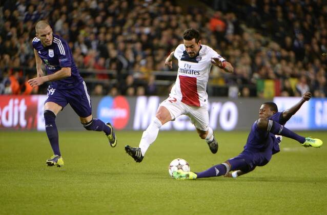 :Chancel Mbemba of RSC Anderlecht and Bram Nuytinck of RSC Anderlecht with Ezequiel Lavezzi of PSG RSC Anderlecht vs PSG Paris Saint Germain - 23 10 2013 PhotoNews Panoramic 