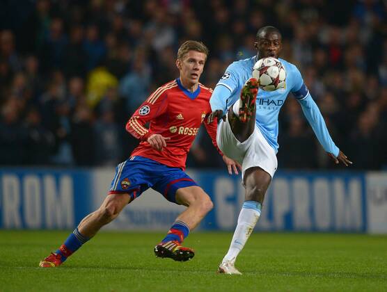Yaya Toure of Manchester City tussles with Pontus Wernbloom of CSKA Moscow - UEFA Champions League Group D - Manchester City vs CSKA Moscow - Etihad Stadium - Manchester - England - 05 11 13 - EDITORIAL USE ONLY. No use with unauthorised audio, video, data, fixture lists, club league logos or live services. Online in-match use limited to 120 images, no video emulation. No use in betting, games or single club league player publications.