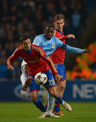 Yaya Toure of Manchester City tussles with Georgi Milanov of CSKA Moscow - UEFA Champions League Group D - Manchester City vs CSKA Moscow - Etihad Stadium - Manchester - England - 05 11 13 - EDITORIAL USE ONLY. No use with unauthorised audio, video, data, fixture lists, club league logos or live services. Online in-match use limited to 120 images, no video emulation. No use in betting, games or single club league player publications.