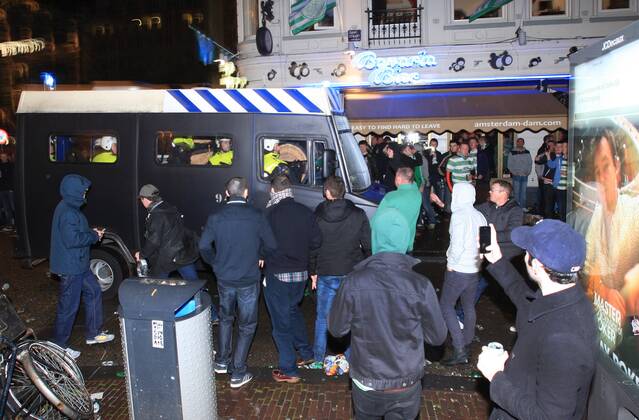 Police tries to control clashes with Celtic s supporters at Dam square downtown Amsterdam on 6 November, 2013. Celtic from Ireland, they play against Ajax Amsterdam for the Champions League football match in Arena tonight. (  pa002 xbyxPauloxAmorim)