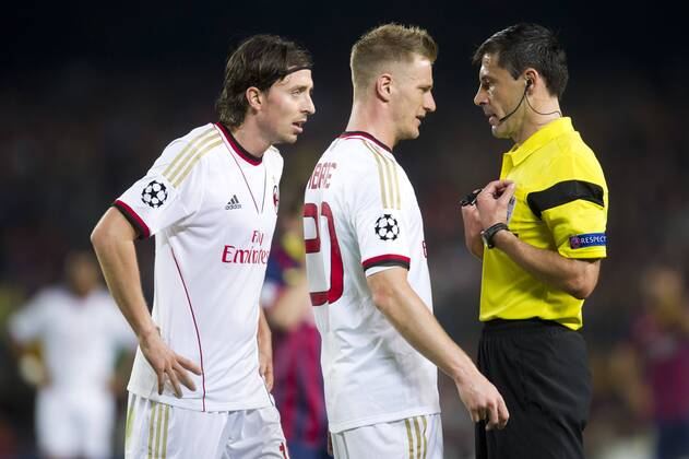 AC Milan s Riccardo Montolivo (left), Ignazio Abate (center) and referee Milorad Mazic during a UEFA Champions League 2013-2014 match between FC Barcelona (Barca) and AC Milan. November 6, 2013.  (20131106016)