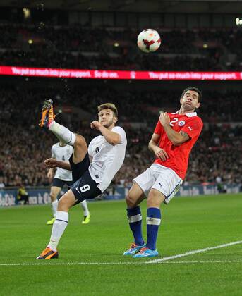 England s Adam Lallana tussles with Chile s Eugenio Mena - England v Chile - International Friendly - Wembley Stadium - London - England -15 11 2013 - Pic David Klein Sportimage EDITORIAL USE ONLY. No use with unauthorised audio, video, data, fixture lists, club league logos or live services. Online in-match use limited to 120 images, no video emulation. No use in betting, games or single club league player publications.