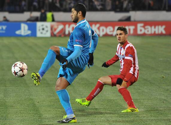 ITAR-TASS: ST PETERSBURG, RUSSIA. NOVEMBER 26, 2013. Zenit s Hulk (L) kicks the ball as an unidentified Atletico player looks on in their UEFA Champions League football match at Petrovsky Stadium.  RE13182E