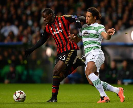 Mario Balotelli of AC Milan tussles with Virgil van Dijk of Celtic - UEFA Champions League Group H - Celtic vs AC Milan - Celtic Park Stadium - Glasgow - Scotland - 26th November 2013 - EDITORIAL USE ONLY. No use with unauthorised audio, video, data, fixture lists, club league logos or live services. Online in-match use limited to 120 images, no video emulation. No use in betting, games or single club league player publications.