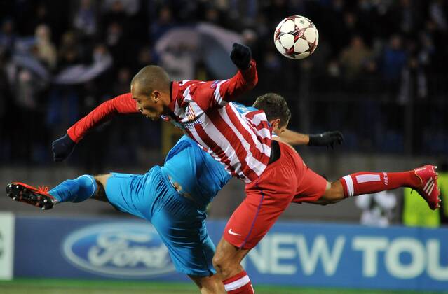 ITAR-TASS: ST PETERSBURG, RUSSIA. NOVEMBER 26, 2013. Atletico s Joao Miranda (R) in action in the UEFA Champions League football match against Zenit St Petersburg at Petrovsky Stadium. The game ended in a 1:1 draw.  premiumd 20158482