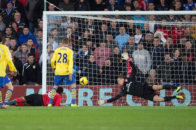 Arsenal s Wojciech Szczesny makes a low save following a headed attempt on goal from Cardiff s Fraizer Campbell - Cardiff City vs. Arsenal FC London - Barclays Premier League - Cardiff City Stadium - Cardiff - 30 11 2013 EDITORIAL USE ONLY. No use with unauthorised audio, video, data, fixture lists, club league logos or live services. Online in-match use limited to 120 images, no video emulation. No use in betting, games or single club league player publications.