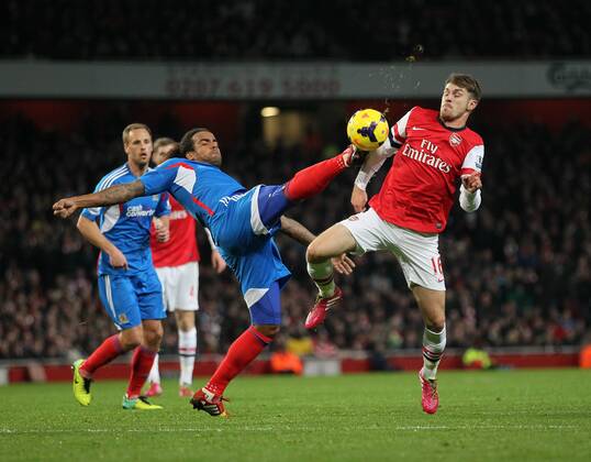 Arsenal s Aaron Ramsey tussles with Hull s Tom Huddlestone Arsenal v Hull City - Premier League - Emirates Stadium - London - 04 12 2013 - Pic David Klein Sportimage EDITORIAL USE ONLY. No use with unauthorised audio, video, data, fixture lists, club league logos or live services. Online in-match use limited to 120 images, no video emulation. No use in betting, games or single club league player publications.