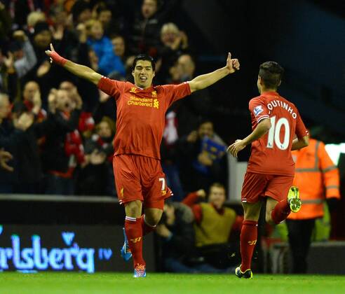 Luis Suarez of Liverpool celebrates his first goal - Barclays Premier League - Liverpool vs Norwich City - Anfield Stadium - Liverpool - England - 4th December 2013 - Picture Simon Bellis Sportimage EDITORIAL USE ONLY. No use with unauthorised audio, video, data, fixture lists, club league logos or live services. Online in-match use limited to 120 images, no video emulation. No use in betting, games or single club league player publications.