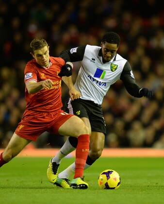 Jordan Henderson of Liverpool tussles with Sebastien Bassong of Norwich City - Barclays Premier League - Liverpool vs Norwich City - Anfield Stadium - Liverpool - England - 4th December 2013 - Picture Simon Bellis Sportimage EDITORIAL USE ONLY. No use with unauthorised audio, video, data, fixture lists, club league logos or live services. Online in-match use limited to 120 images, no video emulation. No use in betting, games or single club league player publications.