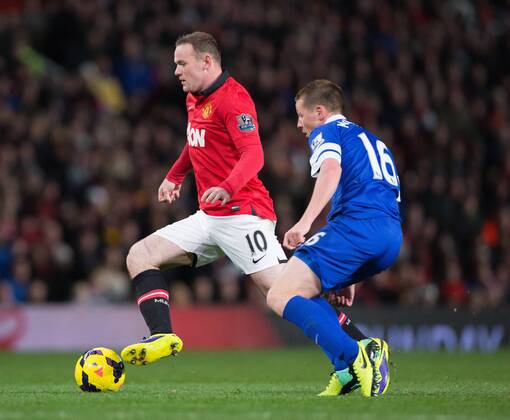 Wayne Rooney of Manchester United struggles to pass James McCarthy of Everton - Manchester United vs. Everton - Barclays Premier League - Old Trafford - Manchester - 04 12 2013 Pic Philip Oldham Sportimage EDITORIAL USE ONLY. No use with unauthorised audio, video, data, fixture lists, club league logos or live services. Online in-match use limited to 120 images, no video emulation. No use in betting, games or single club league player publications.