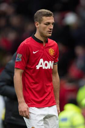 Nemanja Vidic of Manchester United leaves the pitch looking dejected and with a swollen eye following defeat - Manchester United vs. Newcastle United - Barclays Premier League - Old Trafford - Manchester - 04 12 2013 Pic Philip Oldham Sportimage EDITORIAL USE ONLY. No use with unauthorised audio, video, data, fixture lists, club league logos or live services. Online in-match use limited to 120 images, no video emulation. No use in betting, games or single club league player publications.