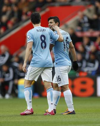 Manchester City s Sergio Kun Aguero celebrates scoring his sides opening goal with Samir Nasri by getting his cheek pinched Southampton v Manchester City - Premier League - St Mary s - Southampton - 07 12 2013 - Pic David Klein Sportimage EDITORIAL USE ONLY. No use with unauthorised audio, video, data, fixture lists, club league logos or live services. Online in-match use limited to 120 images, no video emulation. No use in betting, games or single club league player publications.