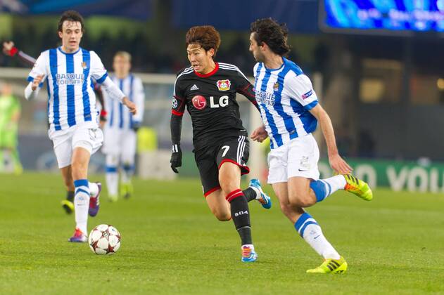 San Sebastian, Spain. 10th December 2013 Bayer 04 Leverkusen s Son Heung-Min (7) and Real Sociedad s Carlos Martinez (2) during the UEFA Champions League Group A match between Real Sociedad and Bayer 04 Leverkusen at Anoeta Stadium 
