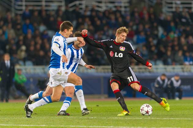 San Sebastian, Spain. 10th December 2013 Bayer 04 Leverkusen s Stefan Kießling (11) and Real Sociedad s Elustondo (4) during the UEFA Champions League Group A match between Real Sociedad and Bayer 04 Leverkusen at Anoeta Stadium 