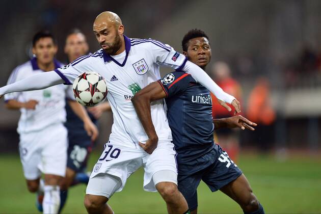 Anthony Vanden Borre of RSC Anderlecht battles for the ball with Michael Olaitan of Olympiacos FC FOOTBALL : Olympiakos vs Anderlecht - Ligue des Champions - 10 12 2013 PHOTONEWS PANORAMIC 