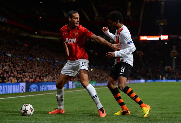 Rio Ferdinand of Manchester United holds off Luiz Adriano of Shakhtar Donetsk - UEFA Champions League Group A - Manchester Utd vs Shakhtar Donetsk - Old Trafford Stadium - Manchester - England - 10 12 13 - Picture Simon Bellis Sportimage EDITORIAL USE ONLY. No use with unauthorised audio, video, data, fixture lists, club league logos or live services. Online in-match use limited to 120 images, no video emulation. No use in betting, games or single club league player publications.