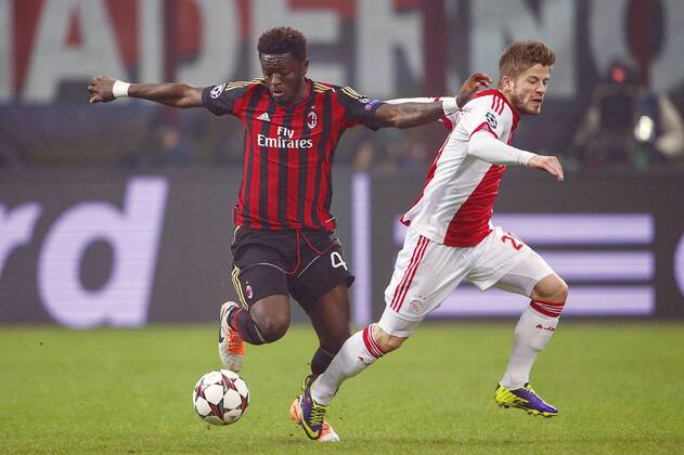 (L-R) Sulley Muntari of AC Milan, Lasse Schone of Ajax during the UEFA Champions League match between AC Milan and Ajax Amsterdam on December 11, 2013 at San Siro in Milan, Italy AC Milan v Ajax UEFA Champions League 2013 2014 xVIxxIVx 1952483