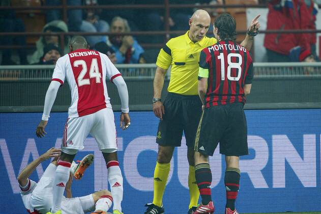 (L-R) Christian Poulsen of Ajax, Stefano Denswil of Ajax, referee Howard Webb, Riccardo Montolivo of AC Milan during the UEFA Champions League match between AC Milan and Ajax Amsterdam on December 11, 2013 at San Siro in Milan, Italy AC Milan v Ajax UEFA Champions League 2013 2014 xVIxxIVx 1952484