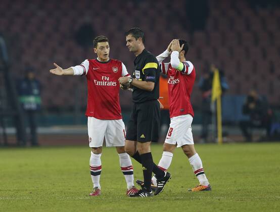 Arsenal s Mesut Ozil looks on dejected as Mikel Arteta gets sent off SSC Napoli - Arsenal FC London. UEFA Champions League - San Paolo Stadium - Naples - Italy - 11 12 2013 - xDavidxKleinx EDITORIAL USE ONLY. No use with unauthorised audio, video, data, fixture lists, club league logos or live services. Online in-match use limited to 120 images, no video emulation. No use in betting, games or single club league player publications.