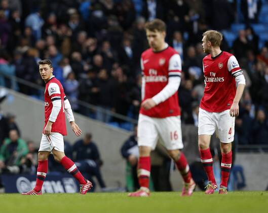 Arsenal s Mesut Ozil has an arguement with Per Mertesacker at the final whistle Manchester City vs Arsenal - Premier League - Etihad Stadium - Manchester - England - 14 12 2013 - EDITORIAL USE ONLY. No use with unauthorised audio, video, data, fixture lists, club league logos or live services. Online in-match use limited to 120 images, no video emulation. No use in betting, games or single club league player publications.