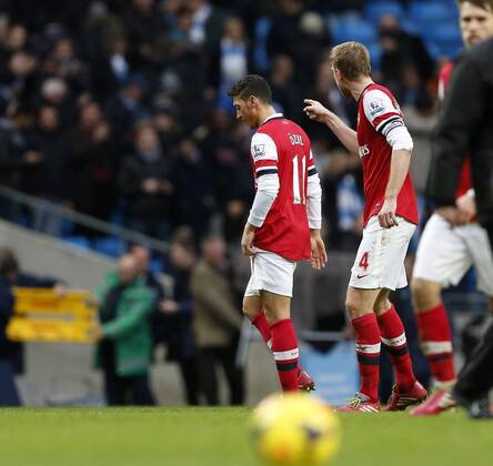 Arsenal s Mesut Ozil has an arguement with Per Mertesacker at the final whistle Manchester City vs Arsenal - Premier League - Etihad Stadium - Manchester - England - 14 12 2013 - EDITORIAL USE ONLY. No use with unauthorised audio, video, data, fixture lists, club league logos or live services. Online in-match use limited to 120 images, no video emulation. No use in betting, games or single club league player publications.