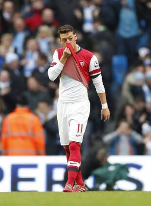 Arsenal s Mesut Ozil looks on dejected after gifting Manchester City there third goal Manchester City vs Arsenal - Premier League - Etihad Stadium - Manchester - England - 14 12 2013 - EDITORIAL USE ONLY. No use with unauthorised audio, video, data, fixture lists, club league logos or live services. Online in-match use limited to 120 images, no video emulation. No use in betting, games or single club league player publications.