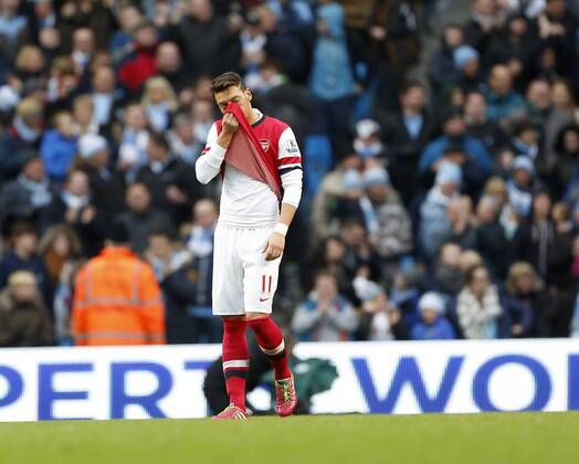 Arsenal s Mesut Ozil looks on dejected after gifting Manchester City there third goal Manchester City vs Arsenal - Premier League - Etihad Stadium - Manchester - England - 14 12 2013 - EDITORIAL USE ONLY. No use with unauthorised audio, video, data, fixture lists, club league logos or live services. Online in-match use limited to 120 images, no video emulation. No use in betting, games or single club league player publications.