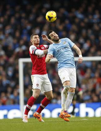 Manchester City s Alvaro Negredo tussles with Arsenal s Thomas Vermaelen Manchester City vs Arsenal - Premier League - Etihad Stadium - Manchester - England - 14 12 2013 - EDITORIAL USE ONLY. No use with unauthorised audio, video, data, fixture lists, club league logos or live services. Online in-match use limited to 120 images, no video emulation. No use in betting, games or single club league player publications.