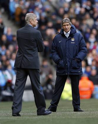 Manchester City s Manuel Pellegrini looks at Arsenal s Arsene Wenger Manchester City vs Arsenal - Premier League - Etihad Stadium - Manchester - England - 14 12 2013 - EDITORIAL USE ONLY. No use with unauthorised audio, video, data, fixture lists, club league logos or live services. Online in-match use limited to 120 images, no video emulation. No use in betting, games or single club league player publications.