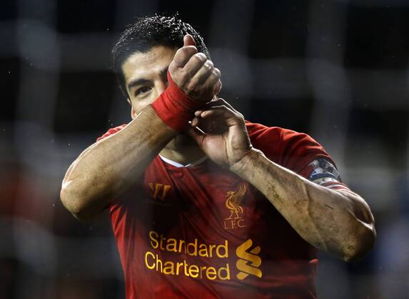 Luis Suarez of Liverpool celebrates scoring their fourth goal during the Barclays Premier League match between Tottenham Hotspur and Liverpool at White Hart Lane in London, Britain on Dec. 15, 2013. Liverpool won 5-0. (Xinhua Wang Lili) FOR EDITORIAL USE ONLY. NOT FOR SALE FOR MARKETING OR ADVERTISING CAMPAIGNS. NO USE WITH UNAUTHORIZED AUDIO, VIDEO, DATA, FIXTURE LISTS, CLUB LEAGUE LOGOS OR LIVE SERVICES. ONLINE IN-MATCH USE LIMITED TO 45 IMAGES, NO VIDEO EMULATION. NO USE IN BETTING, GAMES OR SINGLE CLUB LEAGUE PLAYER PUBLICATIONS. (SP)BRITAIN-LONDON-SOCCER-PREMIER LEAGUE-TOTTENHAM HOTSPUR VS LIVERPOOL
