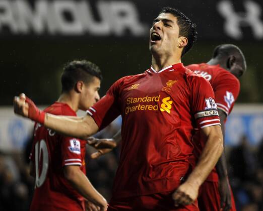 Luis Suarez of Liverpool celebrates scoring their fourth goal during the Barclays Premier League match between Tottenham Hotspur and Liverpool at White Hart Lane in London, Britain on Dec. 15, 2013. Liverpool won 5-0. (Xinhua Wang Lili) FOR EDITORIAL USE ONLY. NOT FOR SALE FOR MARKETING OR ADVERTISING CAMPAIGNS. NO USE WITH UNAUTHORIZED AUDIO, VIDEO, DATA, FIXTURE LISTS, CLUB LEAGUE LOGOS OR LIVE SERVICES. ONLINE IN-MATCH USE LIMITED TO 45 IMAGES, NO VIDEO EMULATION. NO USE IN BETTING, GAMES OR SINGLE CLUB LEAGUE PLAYER PUBLICATIONS. (SP)BRITAIN-LONDON-SOCCER-PREMIER LEAGUE-TOTTENHAM HOTSPUR VS LIVERPOOL
