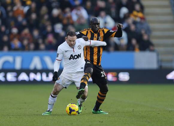 Hull City s Yannick Sagbo tussles with Manchester United s Wayne Rooney Hull City vs Manchester United - Premier League - KC Stadium - London - England - 26 12 2013 - Pic David Klein Sportimage EDITORIAL USE ONLY. No use with unauthorised audio, video, data, fixture lists, club league logos or live services. Online in-match use limited to 120 images, no video emulation. No use in betting, games or single club league player publications.