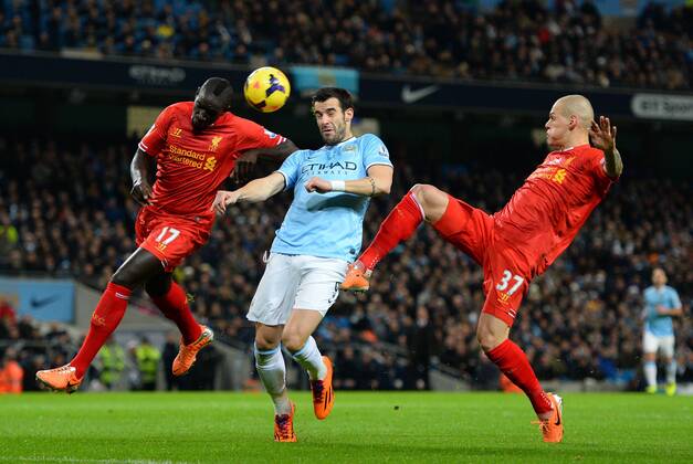 Alvaro Negredo of Manchester City fails to connect as Mamadou Sakho and Martin Skrtel of Liverpool put him off - Barclays Premier League - Manchester City vs Liverpool - Etihad Stadium - Manchester - England - 26th December 2013 - Picture Simon Bellis Sportimage EDITORIAL USE ONLY. No use with unauthorised audio, video, data, fixture lists, club league logos or live services. Online in-match use limited to 120 images, no video emulation. No use in betting, games or single club league player publications.