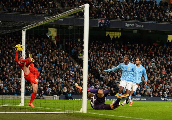 Yaya Toure of Manchester City looks on as Joe Allen of Liverpool tries to keep out a header from Vincent Kompany of Manchester City to equalise - Barclays Premier League - Manchester City vs Liverpool - Etihad Stadium - Manchester - England - 26th December 2013 - Picture Simon Bellis Sportimage EDITORIAL USE ONLY. No use with unauthorised audio, video, data, fixture lists, club league logos or live services. Online in-match use limited to 120 images, no video emulation. No use in betting, games or single club league player publications.