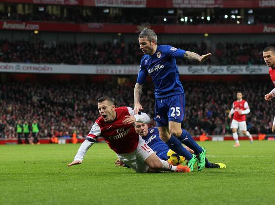 Arsenal s Jack Wilshere gets caught by Cardiff s Gary Medel but no penalty is given Arsenal vs Cardiff - Premier League - Emirates Stadium- London - England - 01 01 2014 - Pic David Klein Sportimage EDITORIAL USE ONLY. No use with unauthorised audio, video, data, fixture lists, club league logos or live services. Online in-match use limited to 120 images, no video emulation. No use in betting, games or single club league player publications.