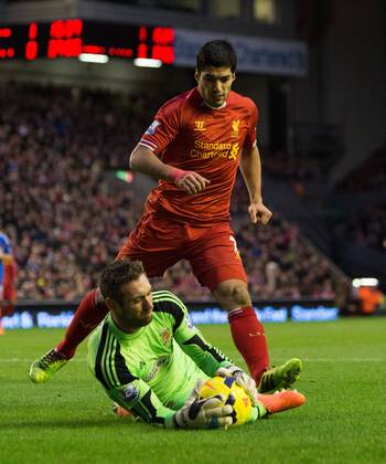 Hull s Allan McGregor smothers the ball denying Luis Suarez of Liverpool - Liverpool vs. Hull City - Barclays Premier League - Anfield - Liverpool - 01 01 2014 Pic Philip Oldham Sportimage EDITORIAL USE ONLY. No use with unauthorised audio, video, data, fixture lists, club league logos or live services. Online in-match use limited to 120 images, no video emulation. No use in betting, games or single club league player publications.