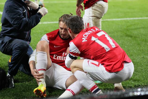 Arsenal s Nicklas Bendtner celebrates scoring his sides opening goal and then goes off injured having hurt his ankle; here with Nacho Monreal - Arsenal FC London vs Cardiff City - Premier League - Emirates Stadium- London - England - 01 01 2014 - EDITORIAL USE ONLY. No use with unauthorised audio, video, data, fixture lists, club league logos or live services. Online in-match use limited to 120 images, no video emulation. No use in betting, games or single club league player publications.