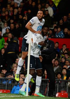 Emmanuel Adebayor of Tottenham celebrates his goal with Mousa Dembele of Tottenham - Barclays Premier League - Manchester Utd vs Tottenham - Old Trafford Stadium - Manchester - England - 1st January 2014 - Picture Simon Bellis Sportimage EDITORIAL USE ONLY. No use with unauthorised audio, video, data, fixture lists, club league logos or live services. Online in-match use limited to 120 images, no video emulation. No use in betting, games or single club league player publications.