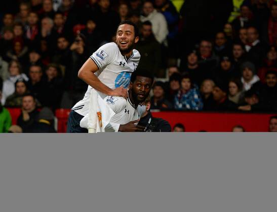 Emmanuel Adebayor of Tottenham celebrates his goal with Mousa Dembele of Tottenham - Barclays Premier League - Manchester Utd vs Tottenham - Old Trafford Stadium - Manchester - England - 1st January 2014 - Picture Simon Bellis Sportimage EDITORIAL USE ONLY. No use with unauthorised audio, video, data, fixture lists, club league logos or live services. Online in-match use limited to 120 images, no video emulation. No use in betting, games or single club league player publications.