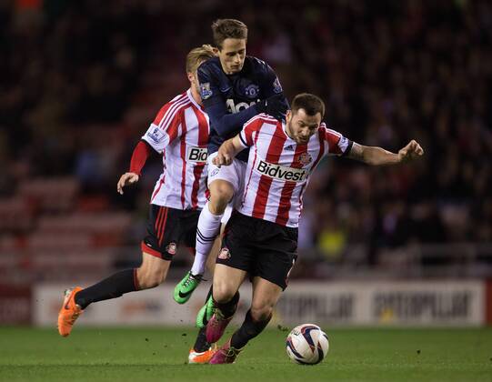 Phil Bardsley of Sunderland challenges Adnan Januzaj of Manchester United - AFC Sunderland vs. Manchester United (ManU) - Capital One Cup SemiFinal First Leg - Stadium of Light - Sunderland - 07 01 2014 EDITORIAL USE ONLY. No use with unauthorised audio, video, data, fixture lists, club league logos or live services. Online in-match use limited to 120 images, no video emulation. No use in betting, games or single club league player publications.