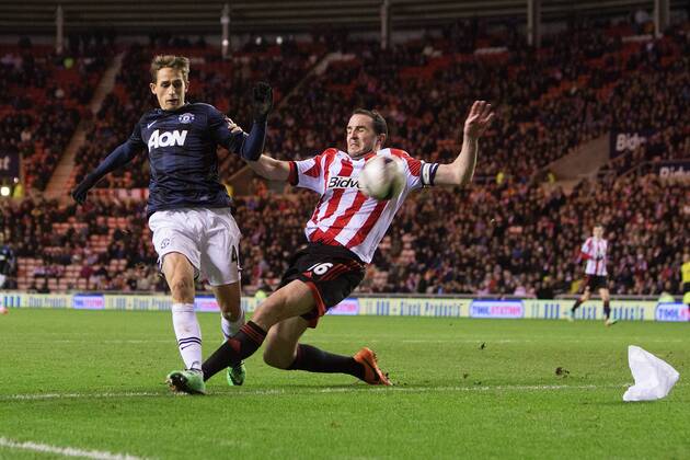 John O Shea of Sunderland puts in a last minute challenge on Adnan Januzaj of Manchester United - AFC Sunderland vs. Manchester United (ManU) - Capital One Cup Semi Final First Leg - Stadium of Light - Sunderland - 07 01 2014 EDITORIAL USE ONLY. No use with unauthorised audio, video, data, fixture lists, club league logos or live services. Online in-match use limited to 120 images, no video emulation. No use in betting, games or single club league player publications.
