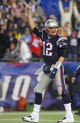 New England Patriots quarterback Tom Brady (12) points his finger in the air after a three-yard touchdown run by running back Stevan Ridley (not picuted) in the third quarter against the Indianapolis Colts in the AFC Divisional Playoff game at Gillette Stadium in Foxboro, Massachusetts on January 11, 2014. The Patriots defeated the Colts 43-22.  BOS2014011107