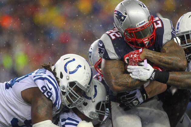 New England Patriots running back Stevan Ridley (22) charges into the end zone on a two-point conversion as Indianapolis Colts defensive end Ricky Jean Francois (99) tries to drag him down in the third quarter of the AFC Divisional Playoff game at Gillette Stadium in Foxboro, Massachusetts on January 11, 2014. The Patriots defeated the Colts 43-22.  BOS2014011108