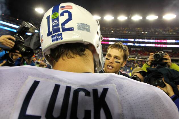 Indianapolis Colts quarterback Andrew Luck (12) shakes hands with New England Patriots quarterback Tom Brady (12) at the end of the AFC Divisional Playoff game at Gillette Stadium in Foxboro, Massachusetts on January 11, 2014. The Patriots defeated the Colts 43-22.  BOS2014011198