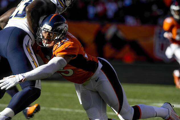 Jan. 12, 2014 - Denver, CO, USA - Denver Broncos cornerback Chris Harris Jr. dives in to tackle San Diego Chargers running back Ronnie Brown during the AFC divisional playoffs in Denver on Sunday, Jan. 12, 2014. BRONCOS CHARGERS - ZUMAm67