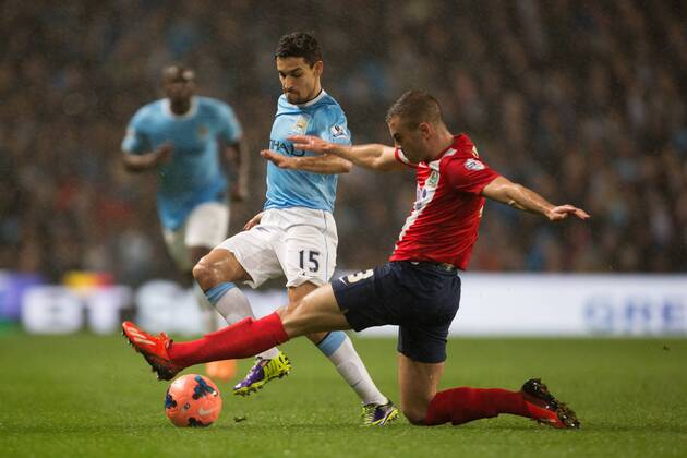 Tommy Spurr of Blackburn Rovers challenges Jesus Navas of Manchester City - Manchester City vs. Blackburn Rovers - FA Cup Third Round Replay - Etihad Stadium - Manchester - 15 01 2014 Pic Philip Oldham Sportimage EDITORIAL USE ONLY. No use with unauthorised audio, video, data, fixture lists, club league logos or live services. Online in-match use limited to 120 images, no video emulation. No use in betting, games or single club league player publications.