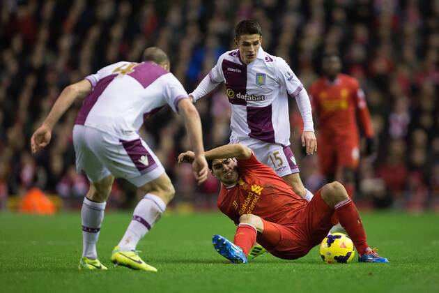 Luis Suarez of Liverpool struggles to stay on his feet under pressure from Ashley Westwood of Aston Villa - Liverpool FC vs. Aston Villa - Barclays Premier League - Anfield - Liverpool - 18 01 2014 Pic PhilipxOldham Sportimage EDITORIAL USE ONLY. No use with unauthorised audio, video, data, fixture lists, club league logos or live services. Online in-match use limited to 120 images, no video emulation. No use in betting, games or single club league player publications.