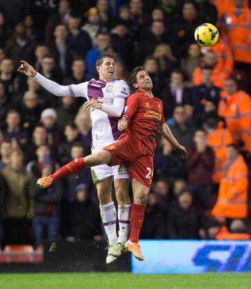 Grant Holt of Aston Villa battles Joe Allen of Liverpool for a high ball - Liverpool FC vs. Aston Villa - Barclays Premier League - Anfield - Liverpool - 18 01 2014 Pic PhilipxOldham Sportimage EDITORIAL USE ONLY. No use with unauthorised audio, video, data, fixture lists, club league logos or live services. Online in-match use limited to 120 images, no video emulation. No use in betting, games or single club league player publications.
